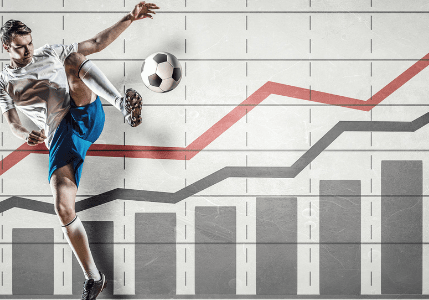 A soccer player kicks a ball in front of a wall with bar charts and upward-trending lines, symbolizing growth and progress driven by a sports and entertainment marketing agency.